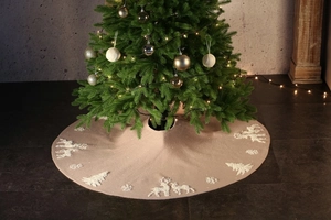 Detail of knitted Christmas tree skirt with white elk and snowflake embroidery patterns