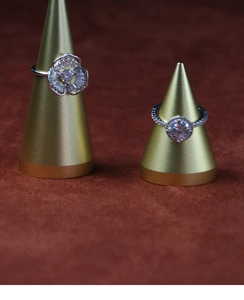 Macro detail of silver rings with sparkling zircon crystals on golden cone displays