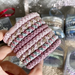 Detailed macro view of woven high-elastic hair ties in various Morandi colors set