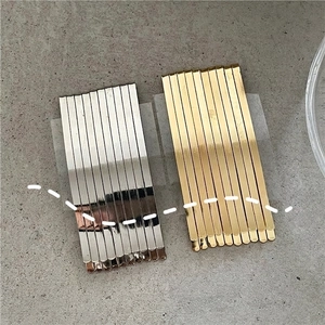 20-piece set of gold and silver minimalist metal hair clips on stone background