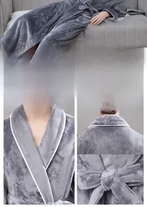 Detail view of the thick flannel bathrobe with contrasting white piping and soft texture