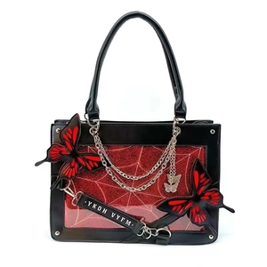 Gothic tote bag detail with red glitter spider web pattern and 3D butterfly charms