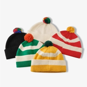 Unisex colorful striped knit beanies with pom-poms in five vibrant winter color styles