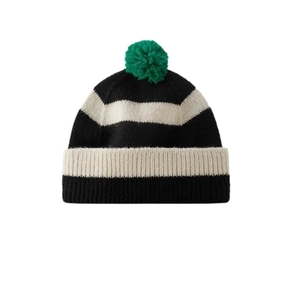 Black and white striped knit beanie featuring a vibrant green pom-pom and ribbed cuff