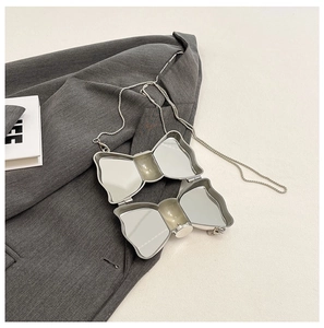 Silver bow-shaped metal folding mirror with an elegant chain strap for women