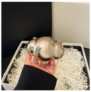Mini gold metal cloud evening bag with chain strap and shiny mirror finish