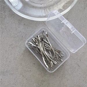 Silver metal hair clip set in a transparent plastic box on a neutral background