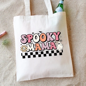 Detail of Spooky Mama print on off-white canvas tote bag with festive Halloween icons