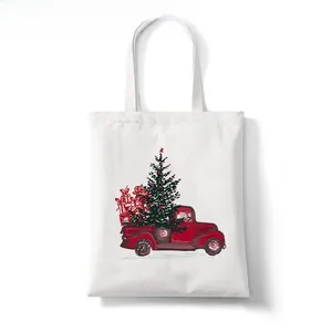 Detail of Christmas white canvas tote bag with festive red truck and tree print design