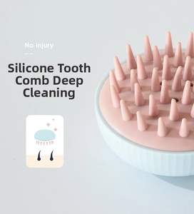 Detail of pink silicone bristles on a blue head massager for deep scalp cleaning