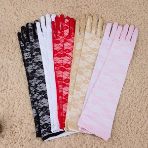 Macro detail of various lace gloves in black white and red with floral texture