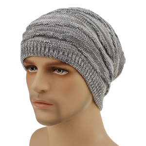 Close-up of gray knitted beanie showing thick ribbed texture and elastic wool fabric
