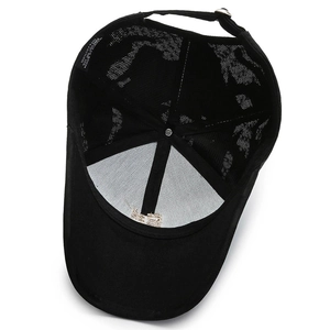 Inside view of black cotton baseball cap showing 100% cotton label and metal buckle