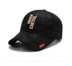 Detail of black baseball cap with grey camo texture and Under Control embroidery