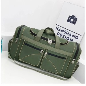 Detail of army green travel bag showing multiple zipper pockets and durable oxford fabric