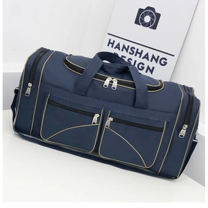 Detail view of large navy travel bag with contrast beige piping and multiple zippers