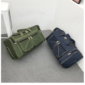 Detail of green and blue lightweight travel bags with durable handles and side pockets
