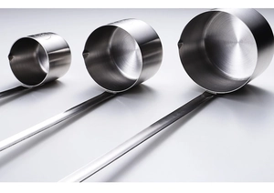 Three long-handled stainless steel measuring scoops with pouring spouts in various sizes