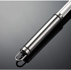 Close-up of brushed stainless steel handle with hanging loop for kitchen oil skimmer