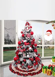 Detail of red plaid tiered tree skirt under a flocked Christmas tree with ornaments