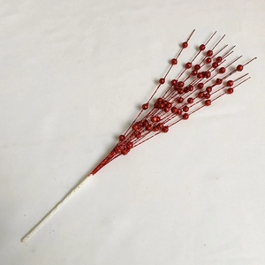 Detail of red glitter berry stems for Christmas tree decoration and festive floral arrangement