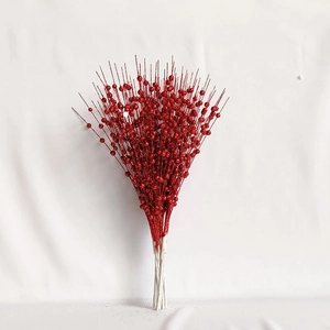 Detail of festive red glitter berry stems with decorative artificial sparkling berries