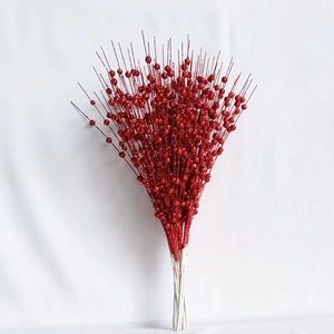 Detail of glittery red berry stems with shiny sequins for Christmas tree decoration