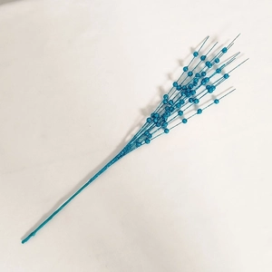 Close-up of blue glitter berry stems with sparkling powder finish for holiday decor