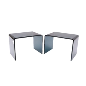 Set of two thick acrylic U-shaped shelving units in transparent smoke grey finish