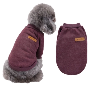 Detail of burgundy pet fleece sweater showing ribbed cuffs and classic leather patch