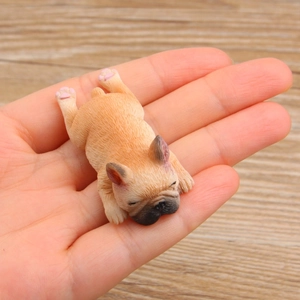 Micro French Bulldog figurine in palm showing realistic fawn fur and sleeping pose