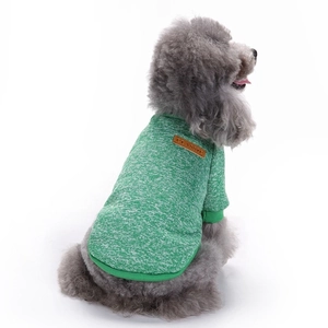 Close-up of green knitted pet sweater showing texture and classic leather patch details