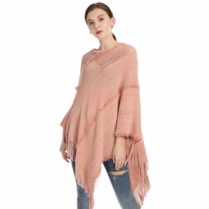 Close-up of pink knit chenille poncho featuring soft fringe details and texture