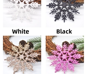Detail of 10cm glitter snowflake ornaments in white, black, gold, and pink with gold strings