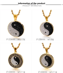 Detail view of four gold stainless steel Yin Yang pendants with black and white rhinestones