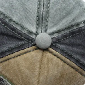 Macro detail of washed cotton baseball cap crown with reinforced stitching and top button