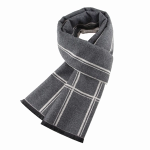 Detailed view of grey striped winter scarf for men with soft brushed texture and black tassels