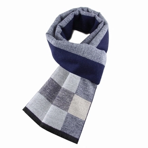 Detailed view of blue grey and beige checkered knit scarf with soft brushed texture