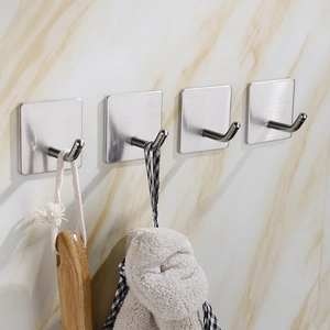 Set of 4 adhesive stainless steel hooks mounted on marble wall for bathroom storage