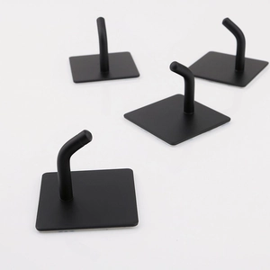 Close-up of four matte black stainless steel L-shaped hooks with square base plates