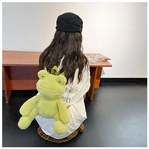 Back view of a model wearing the cute green plush frog-shaped backpack with soft texture