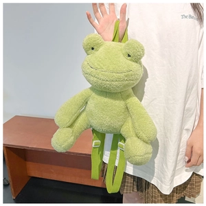 Close-up of cute green plush frog backpack featuring soft material and adjustable straps