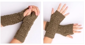 Detailed close-up of olive green cable-knit fingerless arm warmers with thumb hole