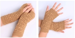 Detail of camel knitted fingerless gloves showing wavy texture and ribbed cuffs