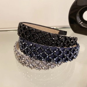 Detailed close-up of handmade crystal beaded headbands in vintage woven lattice design
