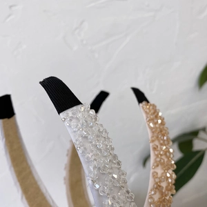 Detail of handcrafted crystal beaded headband with satin fabric and sparkling rhinestones