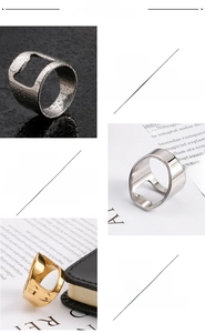 Detail of silver and gold 316L stainless steel rings featuring a bottle opener function
