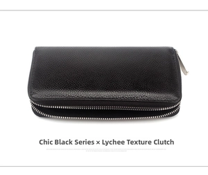 Detail view of black pebbled leather clutch bag featuring dual silver zippers on white background