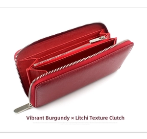 Detail view of burgundy pebble leather wallet interior with multiple slots and zipper pocket