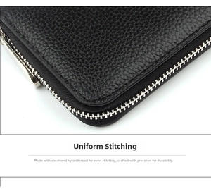 Close-up of uniform stitching on black litchi grain leather wallet with metal zipper